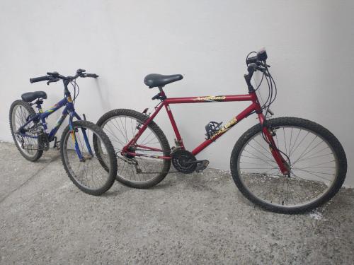 two bikes are parked next to a wall at Casa em Condomínio Fechado in Pelotas