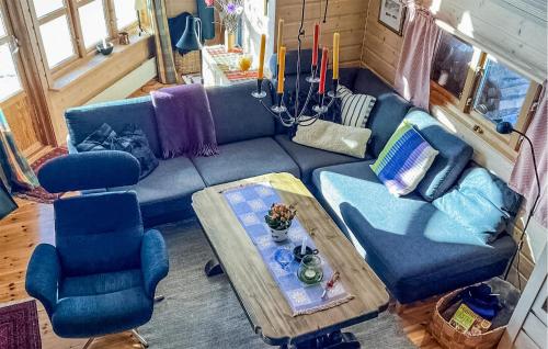 a living room with a blue couch and two chairs at Amazing Home In Dalen With Wifi in Dalen