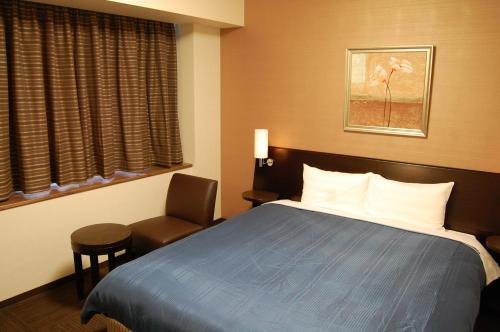 Кровать или кровати в номере Route Inn Grantia Himi Wakuranoyado
