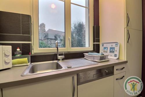 a kitchen with a sink and a window at Evasion in Dinard