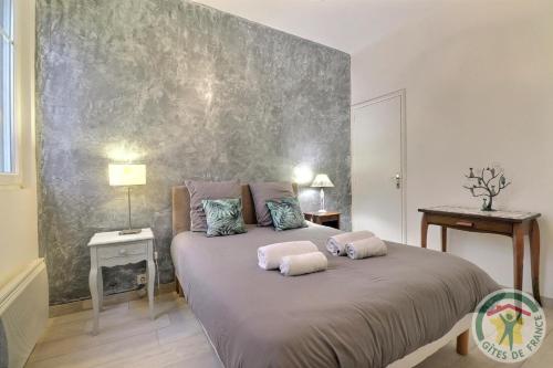 a bedroom with a large bed with two pillows on it at Evasion in Dinard