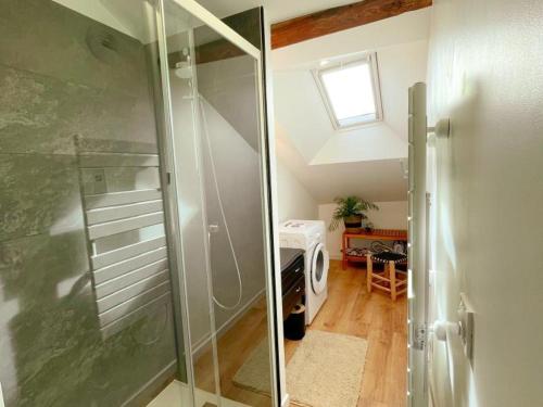 a bathroom with a shower with a glass door at Cosy Gîte à Azay-le-Rideau avec Wifi, Clim, tout inclus, idéal pour 2 adultes et 2 enfants, proche châteaux - FR-1-381-567 in Azay-le-Rideau