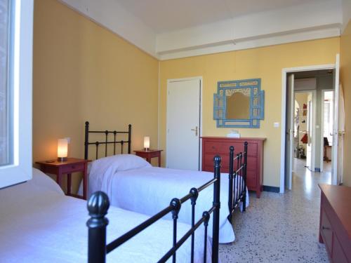 een slaapkamer met 2 bedden en een spiegel bij Appartement Mèze, 4 pièces, 4 personnes - FR-1-604-46 in Mèze