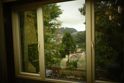 a window with a view of a city at Beverly villa in Ooty