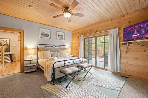 a bedroom with a bed and a ceiling fan at Book For Summer Now! • Pool • Gameroom • Firepit • in Arden