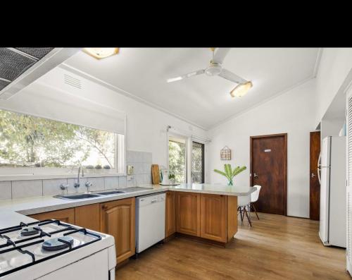 a kitchen with a sink and a stove top oven at Tsapas Homes in Doncaster East