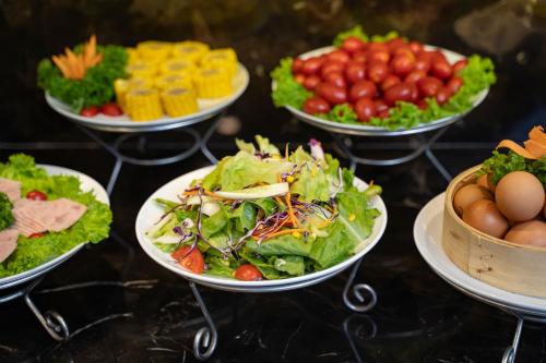 a group of plates of food on a table at Splendid Holiday Hotel Spa in Hanoi