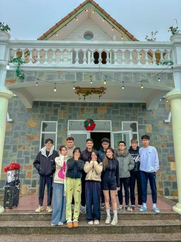 a group of people standing in front of a house at Villa Đường Mây 2 in Tam Ðảo