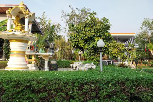 a park with a fountain and a building at Review Resort in Bang Sare