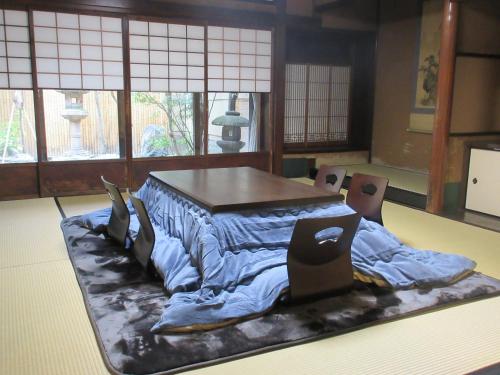 a room with a table with a blanket on it at Tansada Heritage Machiya in Kyoto