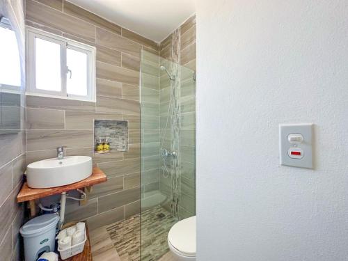 a bathroom with a sink and a glass shower at Cape Coral cabrera 4 in Cabrera