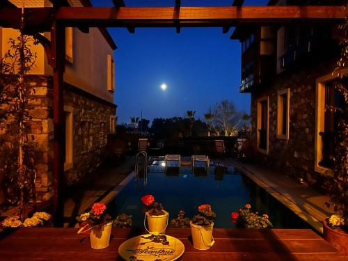 a view of a swimming pool at night at Akanthus Hotel Ephesus in Selcuk