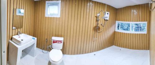 a bathroom with a toilet and a shower and a sink at Chadatarn HomeStay in Ban Pok Nai