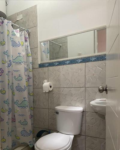 a bathroom with a toilet and a sink and a mirror at Olas inn in Asia