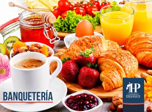 a breakfast table with breakfast foods and a cup of coffee at Hotel Presidente in Santiago