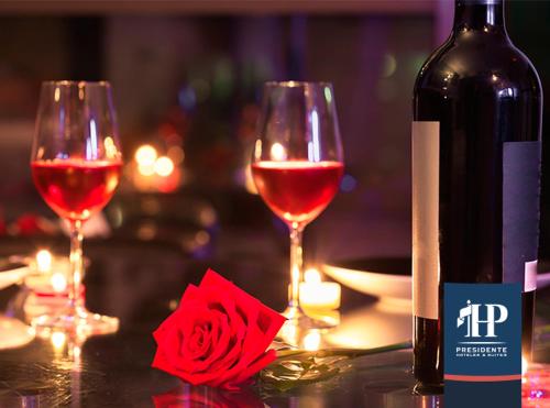 a bottle of wine and two wine glasses on a table at Hotel Presidente in Santiago