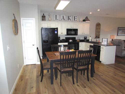 a kitchen and dining room with a table and chairs at Walk-in level Condo B-6 Near Lake in Hollister