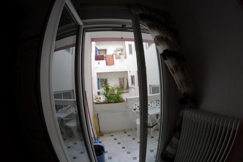 a mirror in a room with a view of a balcony at Igoumenitsa heart flats to let Mariasroom studios appart seaside-city Spyropoulos in Igoumenitsa