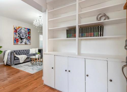 a living room with white cabinets and a couch at La Maison in Vancouver