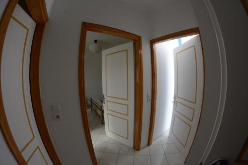 a hallway with two doors and a mirror at Igoumenitsa heart flats to let Mariasroom studios appart seaside-city Spyropoulos in Igoumenitsa