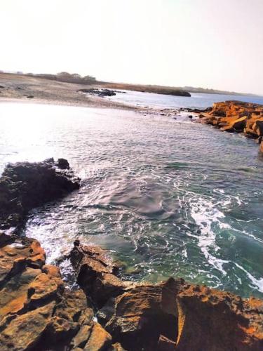 a view of a beach with rocks and water at Feeling Cabo Verde in Beirona