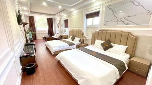 Postel nebo postele na pokoji v ubytování BÔNG SEN HOTEL CÔN ĐẢO