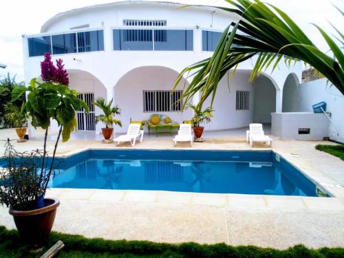 eine Villa mit Swimmingpool und ein Haus in der Unterkunft Keur Fatou in Ngaparou
