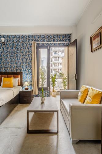 a living room with a couch and a table at Lime Tree Hotel - Golf Course Road, Sector-43, Gurugram in Gurgaon