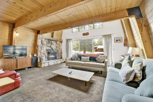 a living room with a couch and a fireplace at Quail's Call Big Bear~ Walk to Lake & Ski Resort in Big Bear Lake