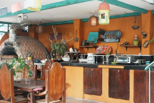 a kitchen with a counter and a table and a stove at Posada 1914 in Panama City