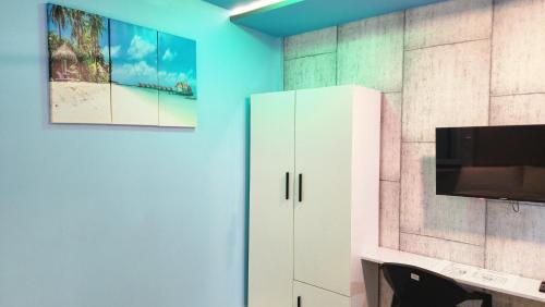 a room with a white cabinet and a tv at Isle inn {Fuvahmulah) in Fuvahmulah