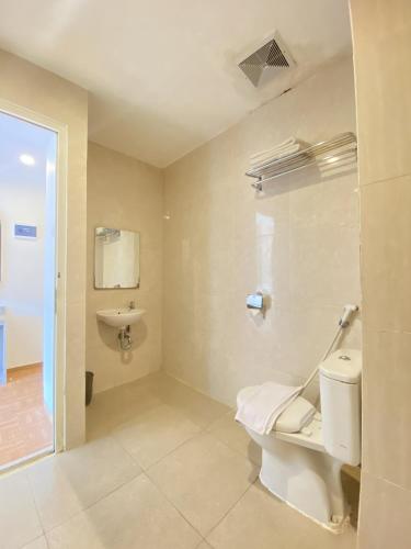 a bathroom with a toilet and a sink at Front One Budget Malang by Azana in Malang
