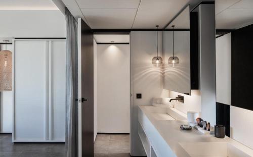 a bathroom with two sinks and a mirror at Luxury Vacation Villa 20 in Pointe Milou