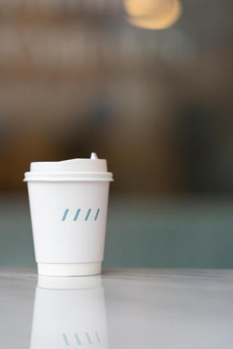 a styrofoam coffee cup sitting on a table at The Verandah - SHA Extra Plus in Ao Nang Beach
