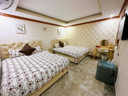 Postel nebo postele na pokoji v ubytování Xing City Hotel Dalat