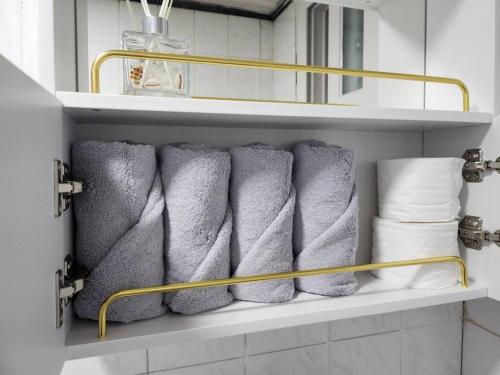 a bunch of towels sitting on a shelf in a bathroom at Yeongdeungpo Windsor in Seoul