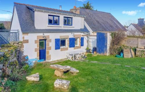 a white house with blue doors and a yard at 2 Bedroom Lovely Home In Pleumeur-Bodou in Pleumeur-Bodou