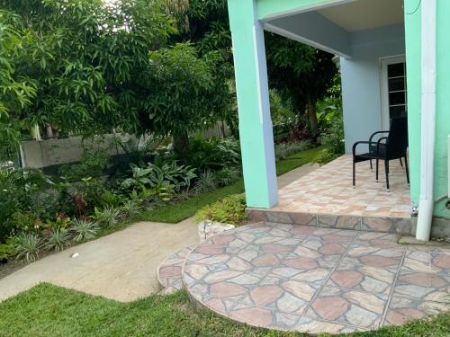 a patio with a table and a chair on a house at Marvey's Place in Castries