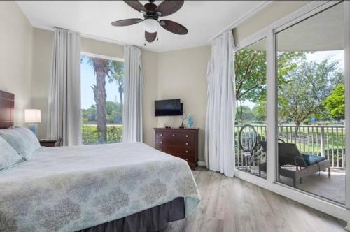 a bedroom with a large bed and a large window at The Palms of Destin-2116 in Destin