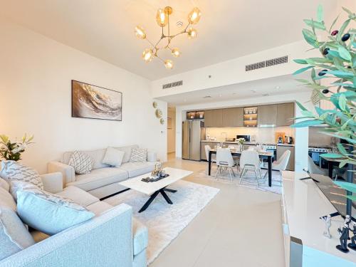 a living room with a couch and a table at First Class Stay in Downtown Dubai Near Burj Park by SBH in Dubai