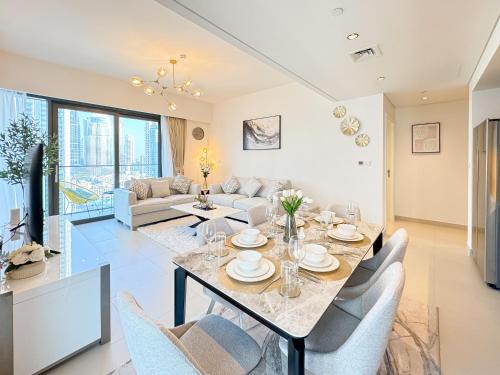 a dining room and living room with a table and chairs at First Class Stay in Downtown Dubai Near Burj Park by SBH in Dubai