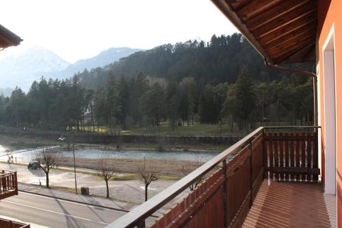 a balcony with a view of a river and mountains at Appartamenti Pedrini in Comano Terme
