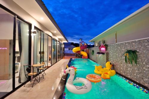 a swimming pool with inflatable animals in a house at NP Pool Villa Hua Hin in Hua Hin