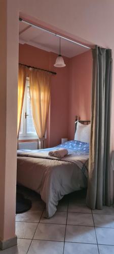 a bedroom with a canopy bed with a window at CAPTAIN DALAS HOME in Mytilini