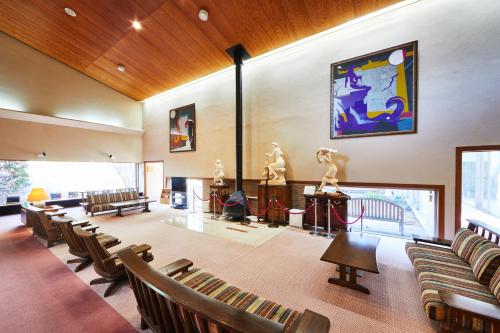 a large room with chairs and statues on display at Shiki Resort Ventvert Karuizawa in Karuizawa