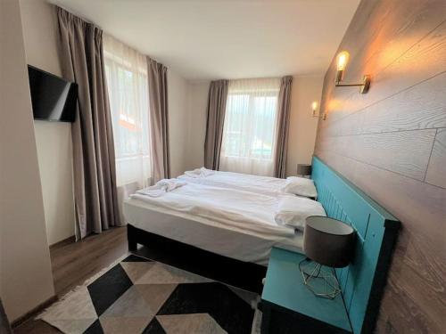 a bedroom with a large bed and a table at Villa in Ruskovets Resort in Dobrinishte