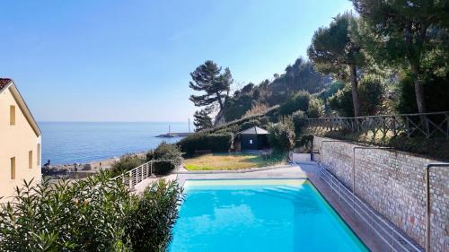 a swimming pool with a view of the ocean at N276 - Numana, bilocale fronte Spiaggiola con piscina in Numana
