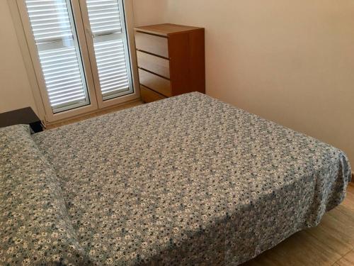 a small bedroom with a bed and a dresser at 3 bedrooms house with wifi at Cartagena in Cartagena