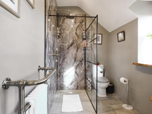 a shower with a glass door in a bathroom at The Red House - Uk39234 in Shelve