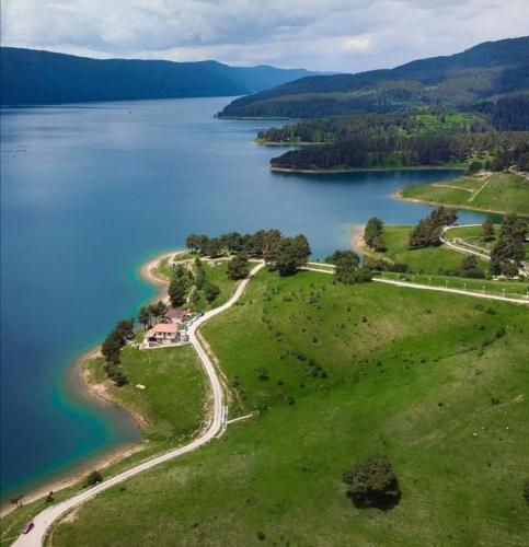 an island in the middle of a large body of water at Divna Guest House in Dospat